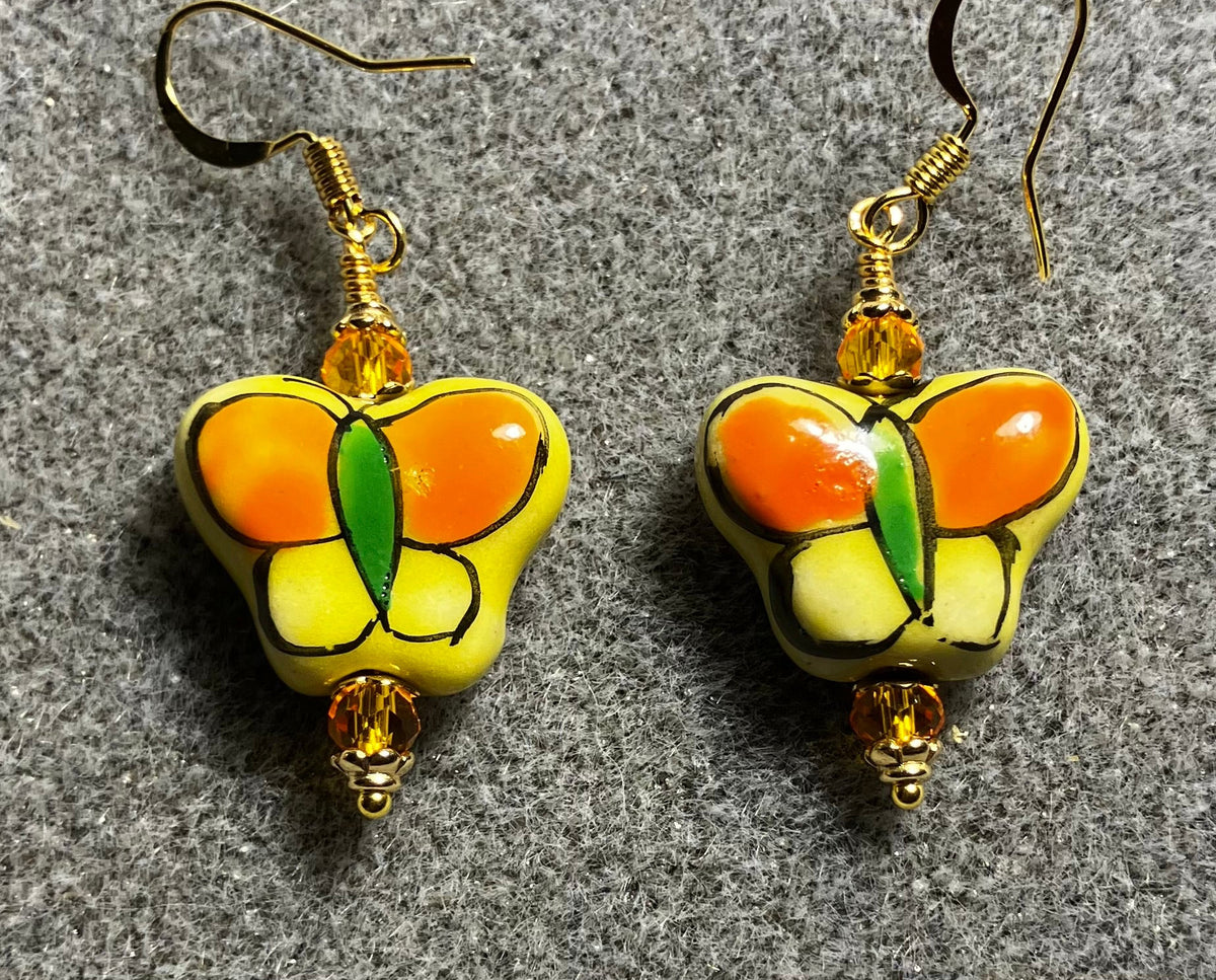 Tangerine and yellow ceramic butterfly bead earrings adorned with tangerine Chinese crystal beads.