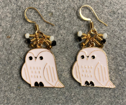 White, black, and gold enamel owl charm earrings adorned with tiny dangling white, black, and gold Chinese crystal beads.