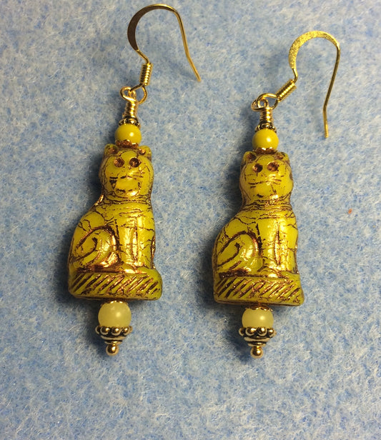 Yellow green Czech glass fancy cat bead earrings adorned with yellow green Czech glass beads.