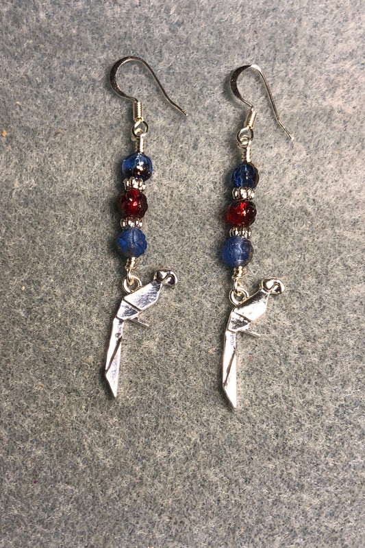 Silver origami parrot charm earrings adorned with small blue and red Czech glass beads.