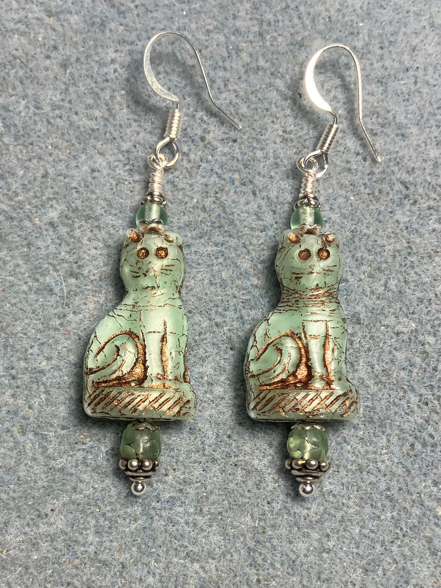 Light green (with copper inlay) fancy Czech glass fancy cat bead earrings adorned with light green Czech glass beads.
