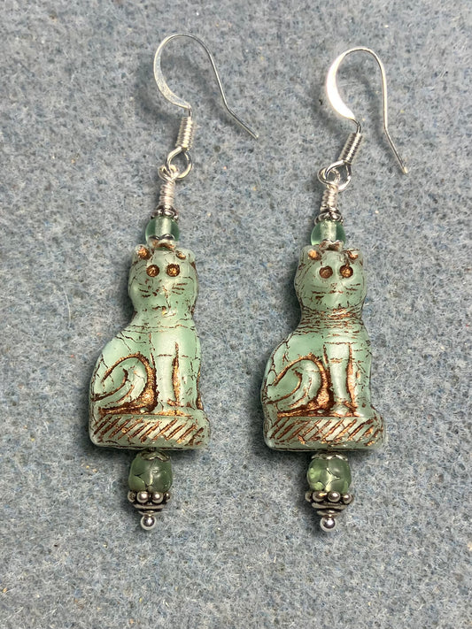 Light green (with copper inlay) fancy Czech glass fancy cat bead earrings adorned with light green Czech glass beads.