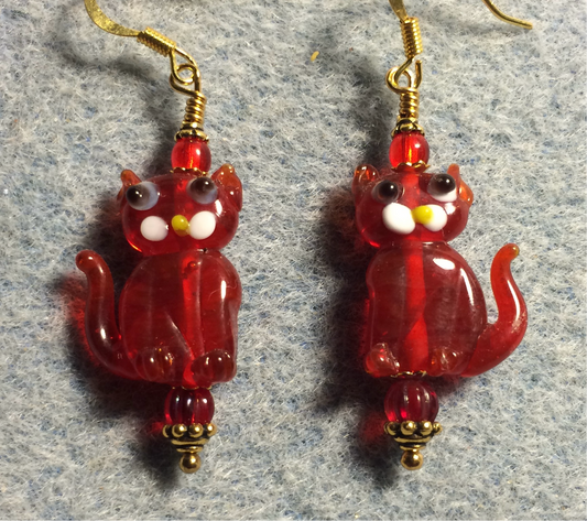Translucent red lamp work cat bead earrings adorned with red Czech glass beads.