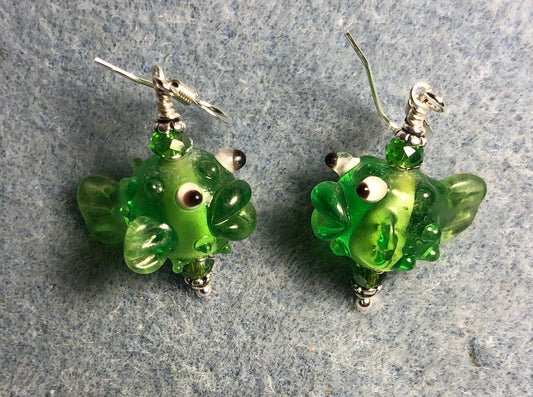 Translucent green lamp work fish bead earrings adorned with green Chinese crystal beads.