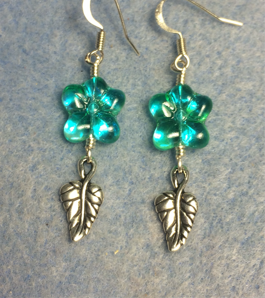 Sparkly turquoise Czech glass puffy flower bead earrings adorned with silver Tierracast leaf charms.