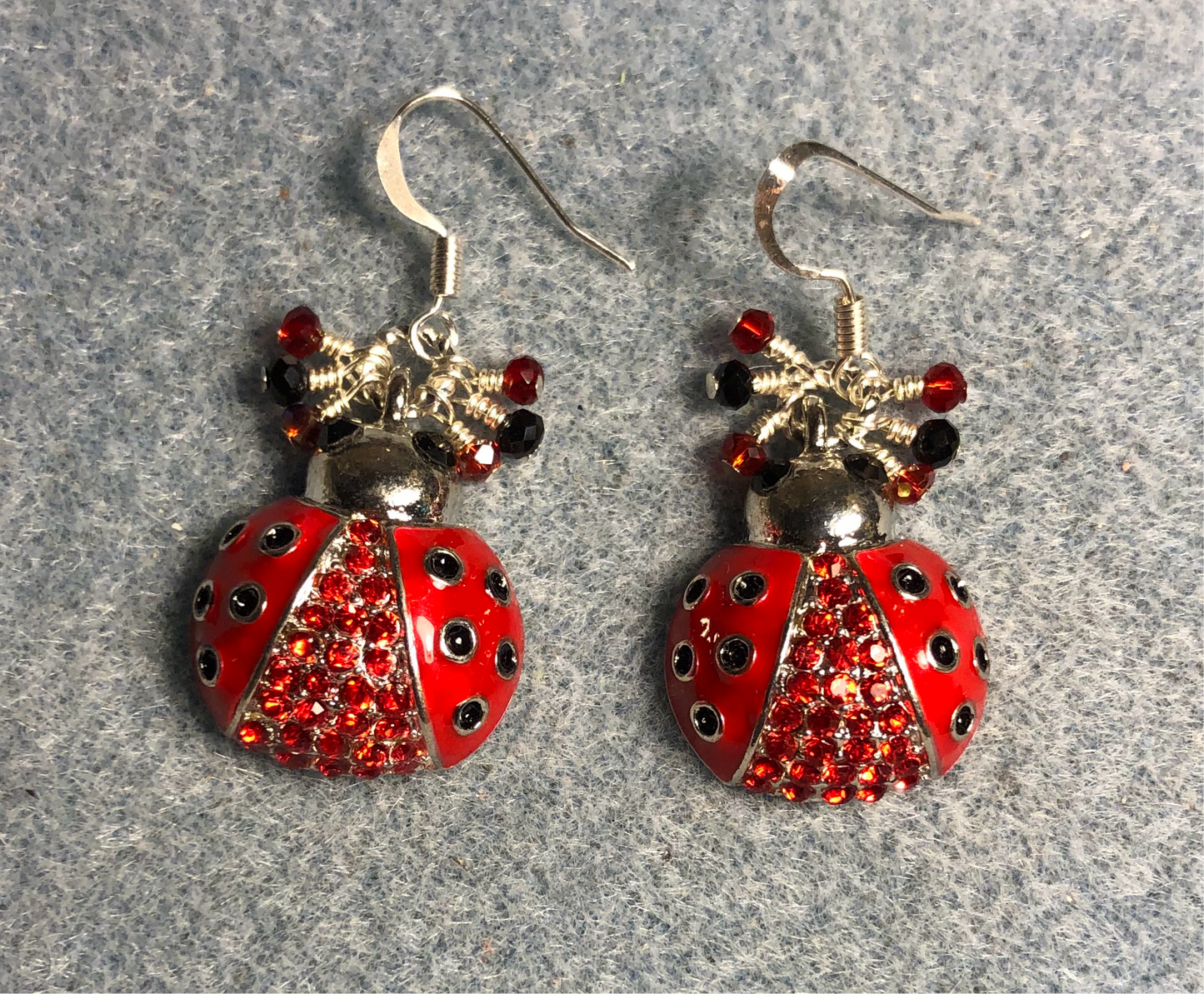 Large red and black enamel and rhinestone ladybug charm earrings adorned with tiny dangling red and black Chinese crystal beads.