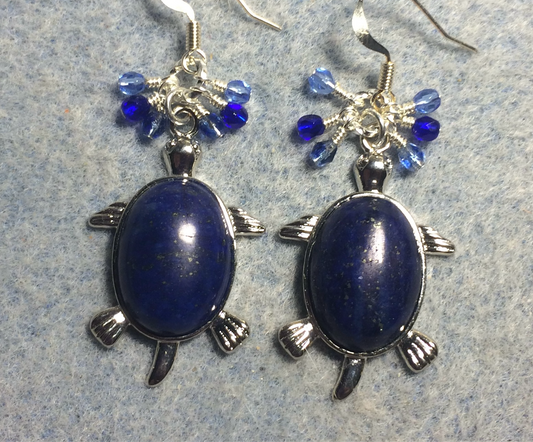 Large silver and blue lapis lazuli gemstone turtle charm earrings adorned with small dangling dark blue and light blue Czech glass beads.