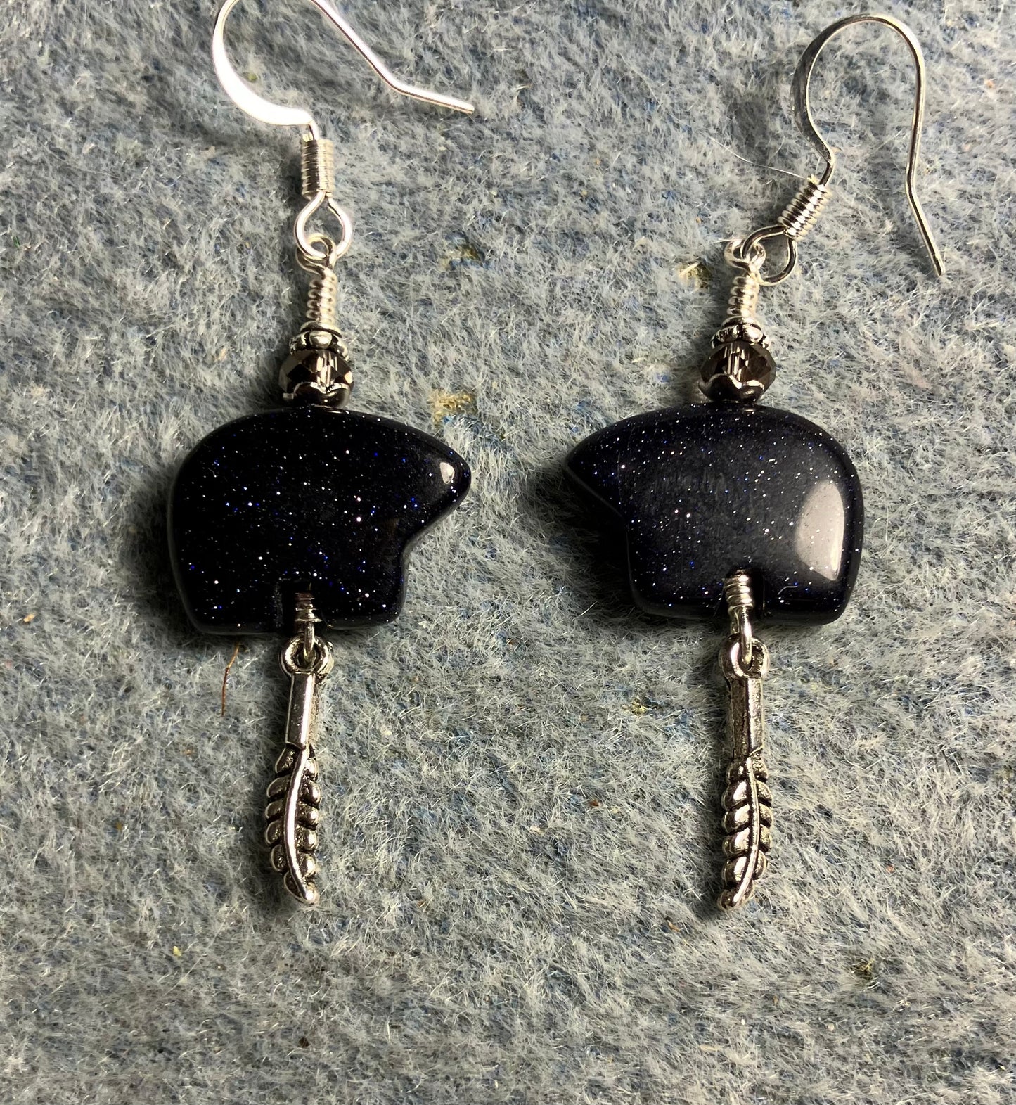 Blue goldstone gemstone Zuni bear fetish bear earrings adorned with purple crystal beads and tiny silver feather charms.