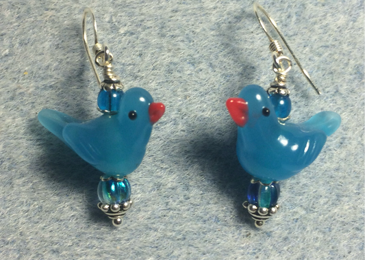 Opaque turquoise lamp work songbird bead earrings adorned with turquoise Czech glass beads.