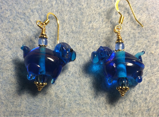 Translucent blue lamp work pig bead earrings adorned with blue Czech glass beads.