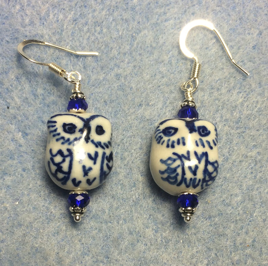 Dark blue ceramic owl bead earrings adorned with dark blue Chinese crystal beads.