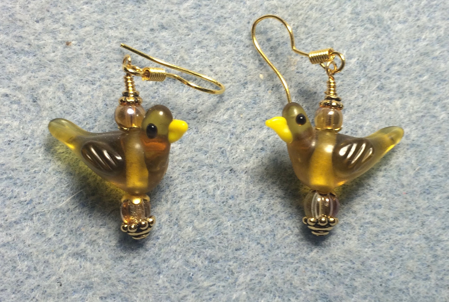 Translucent amber lamp work songbird bead earrings adorned with amber Czech glass beads.
