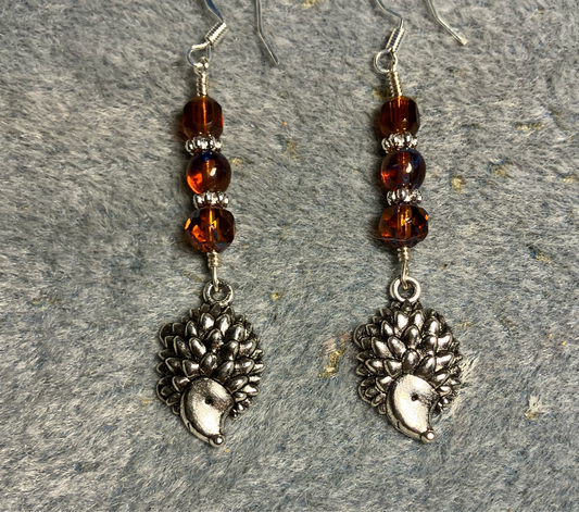 Silver hedgehog charm earrings adorned with topaz Czech glass beads