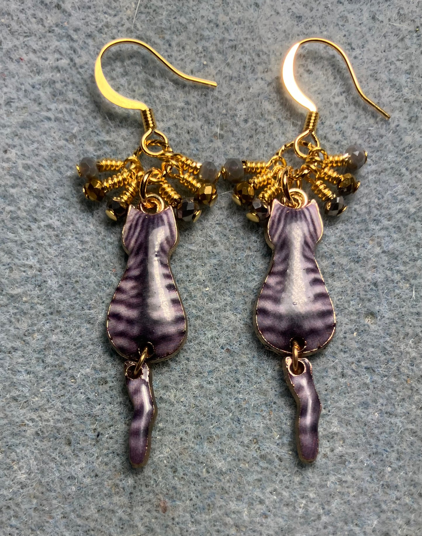 Gray and gold enamel tabby cat charm earrings adorned with tiny dangling gray and gold Chinese crystal beads.