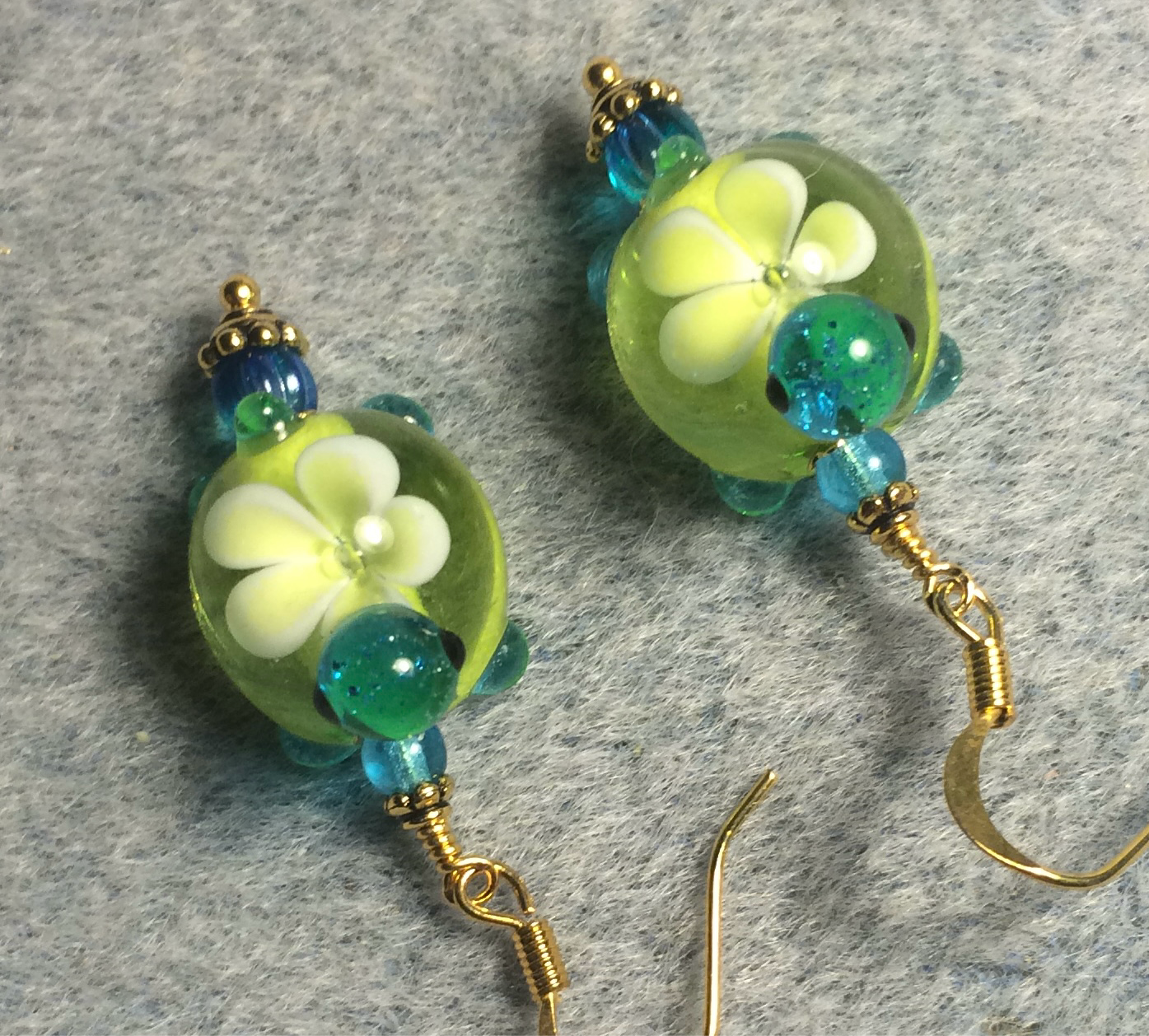 Lime green and turquoise lamp work turtle bead earrings adorned with turquoise Czech glass beads.