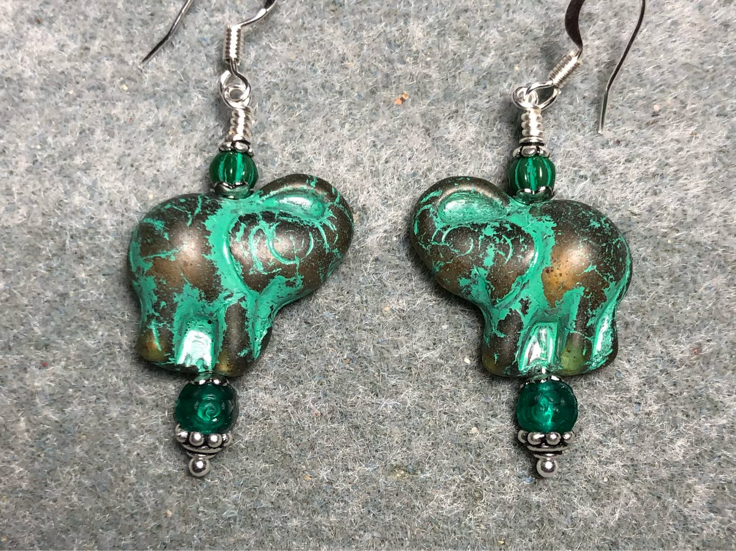 Amber (with green inlay) Czech glass elephant bead earrings adorned with green Czech glass beads.