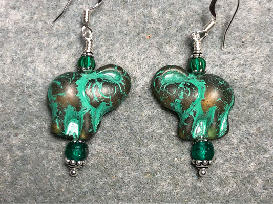 Amber (with green inlay) Czech glass elephant bead earrings adorned with green Czech glass beads.