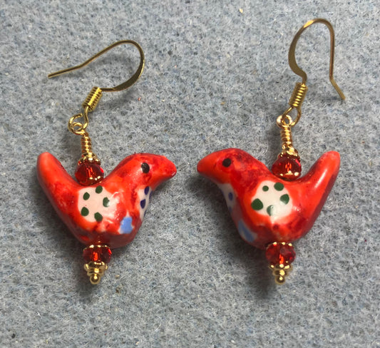 Small red, white, and black ceramic bird bead earrings adorned with red Chinese crystal beads.