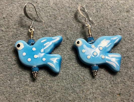 Large turquoise ceramic flying dove bead earrings adorned with turquoise Chinese crystal beads.