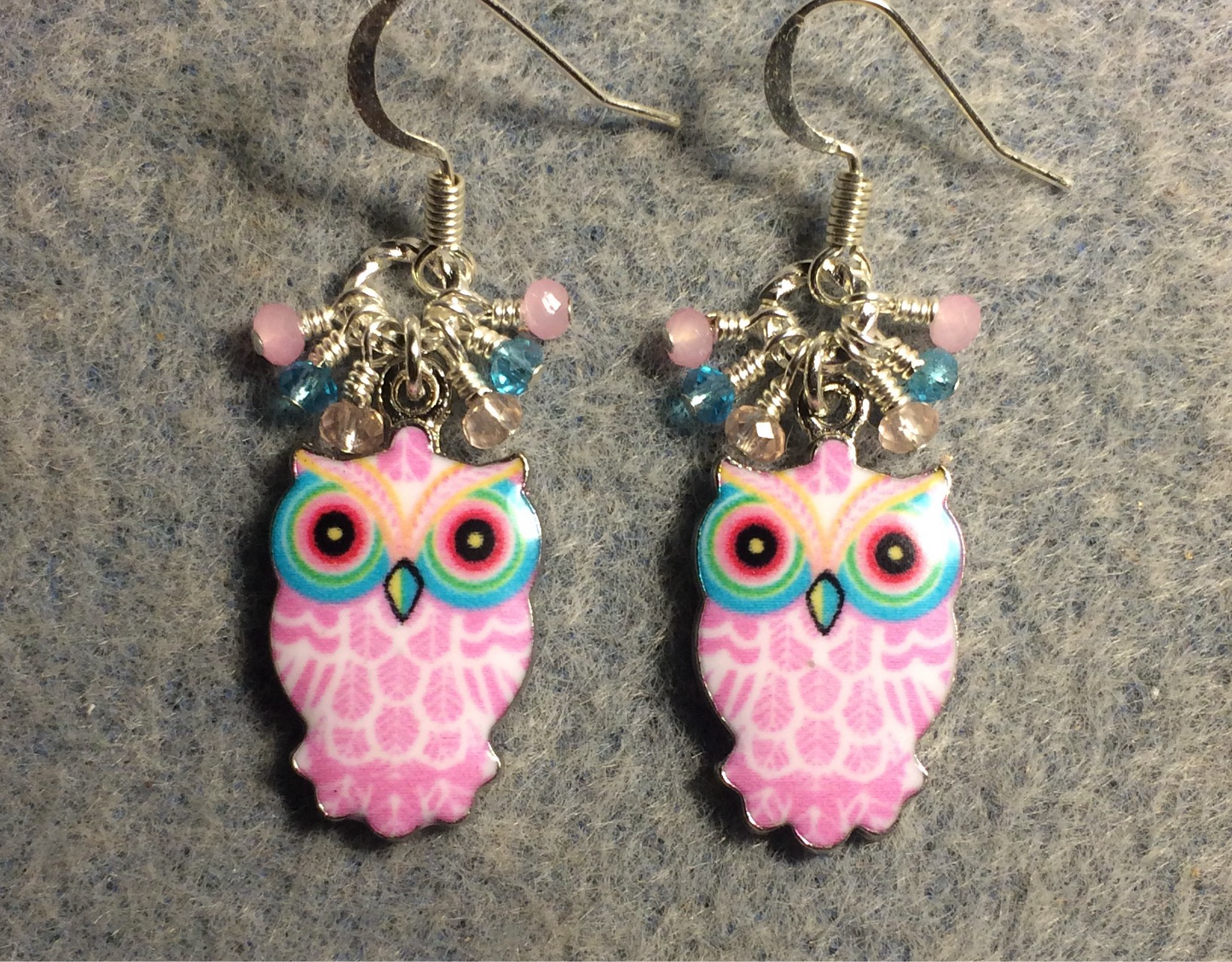 Pink and turquoise enamel owl charm earrings adorned with tiny dangling pink and turquoise Chinese crystal beads.