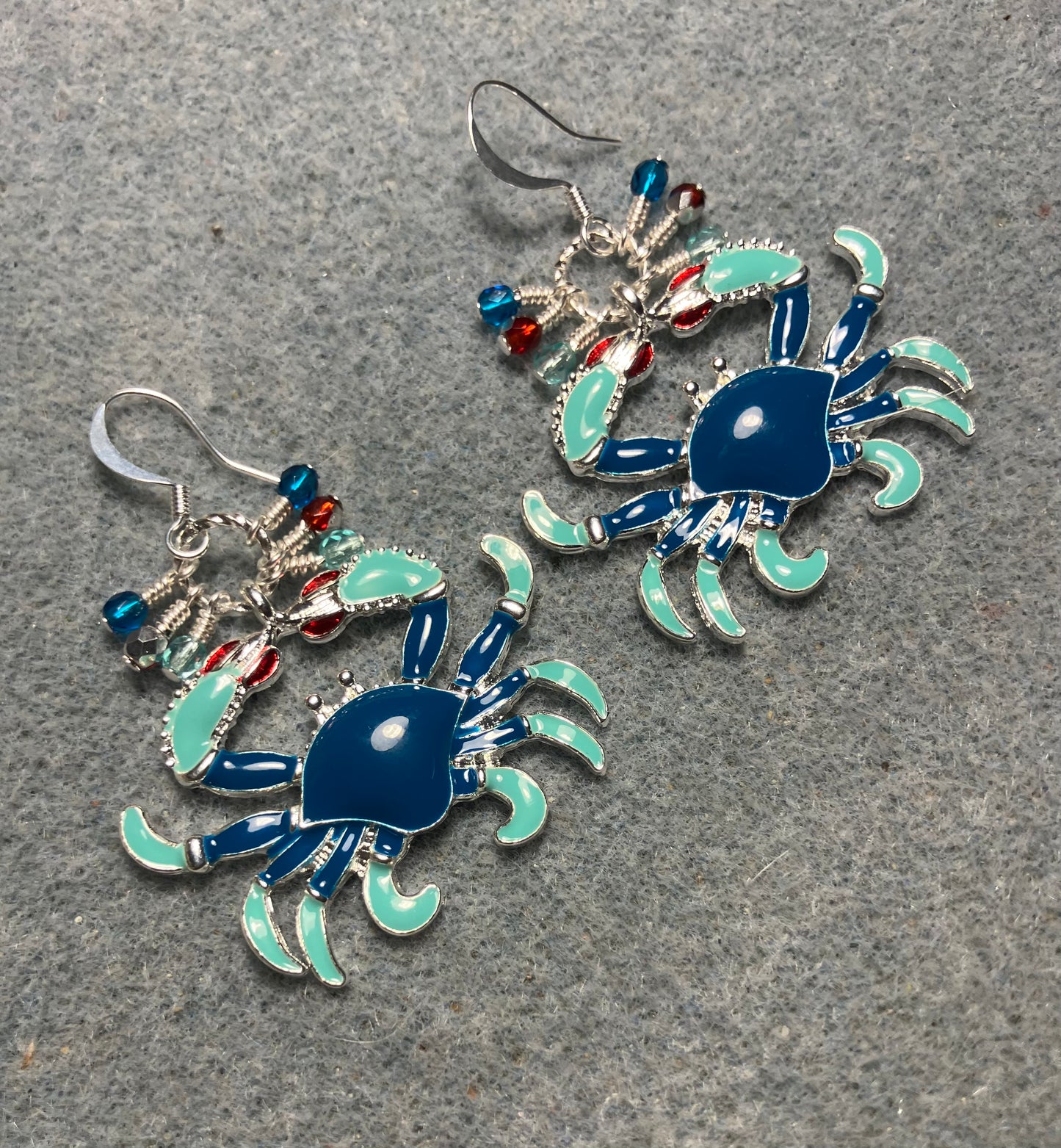 Large blue, aqua, and red enamel crab charm earrings adorned with small dangling blue, aqua, and red Czech glass beads.