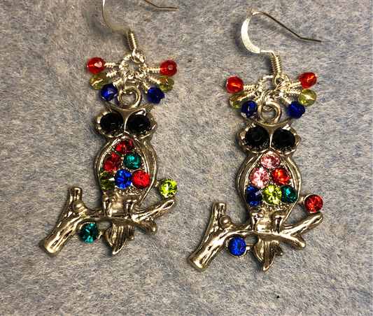 Silver and multicolored rhinestone owl charm earrings adorned with tiny dangling blue, green, and red Czech glass beads.