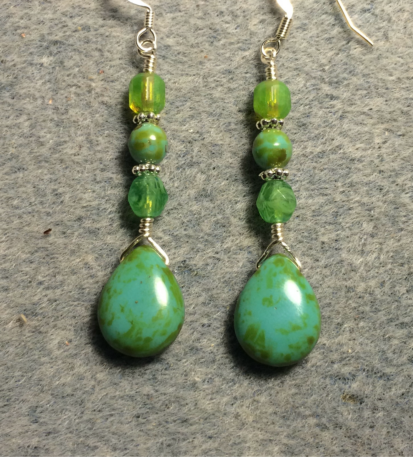 Light green Picasso Czech glass pear drop bead earrings adorned with light green Czech glass beads.