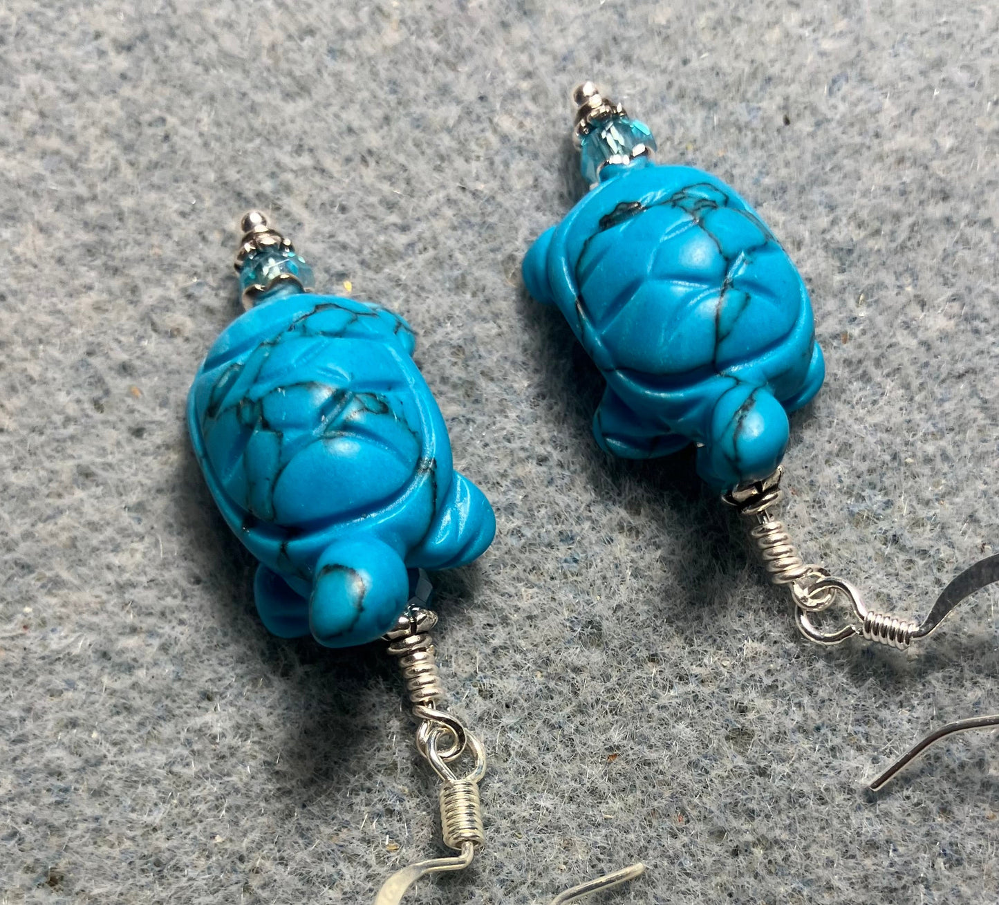 Turquoise howlite gemstone turtle bead earrings adorned with turquoise Chinese crystal beads.