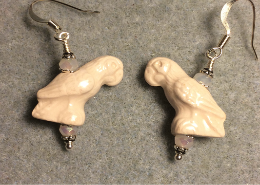 Off white ceramic parrot bead earrings adorned with off white Chinese crystal beads.