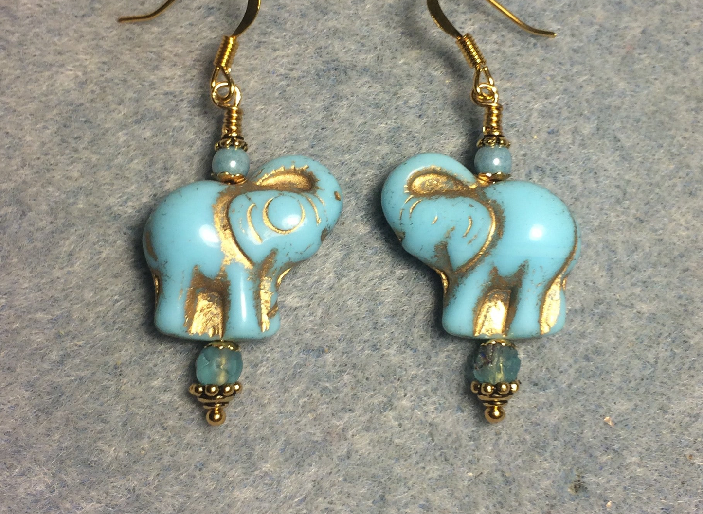 Light aqua (with gold inlay) Czech glass elephant bead earrings adorned with light aqua Czech glass beads.