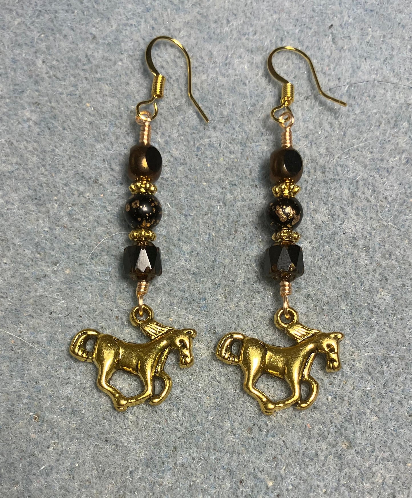 Gold horse charm earrings adorned with black Czech glass beads