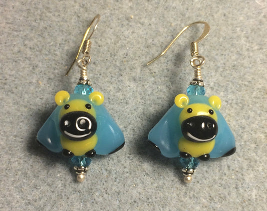 Turquoise, yellow, and black lamp work sheep bead earrings adorned with turquoise Chinese crystal beads.