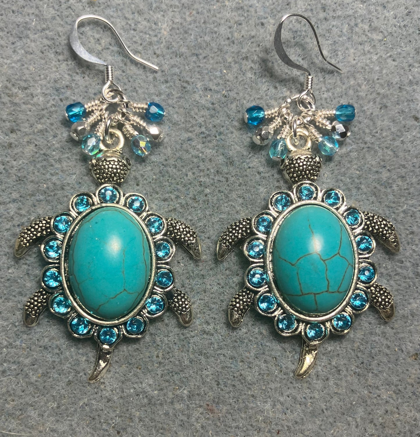 Large silver and turquoise gemstone and rhinestone turtle charm earrings adorned with small dangling turquoise and silver Czech glass beads.