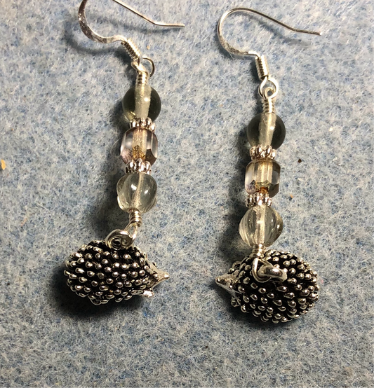 Silver hedgehog charm earrings adorned with silver gray Czech glass beads.
