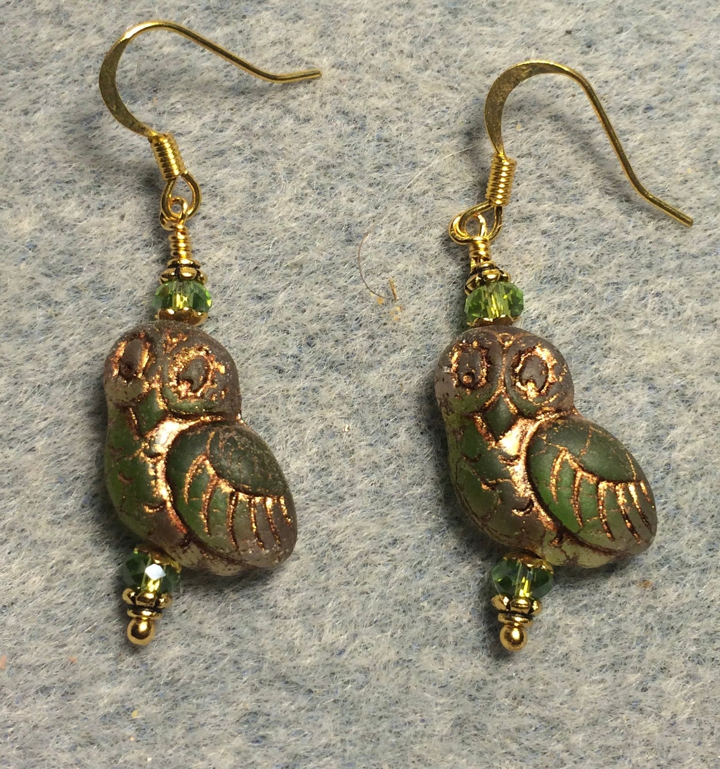 Translucent olive green (with gold wash) fancy Czech glass owl bead earrings adorned with olive green Chinese crystal beads.