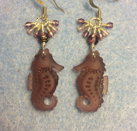 Violet sea glass seahorse pendant bead earrings adorned with violet Czech glass beads and small dangling violet Czech glass beads.