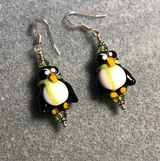 Black, white, and olive green lamp work penguin bead earrings adorned with olive green Chinese crystal beads.