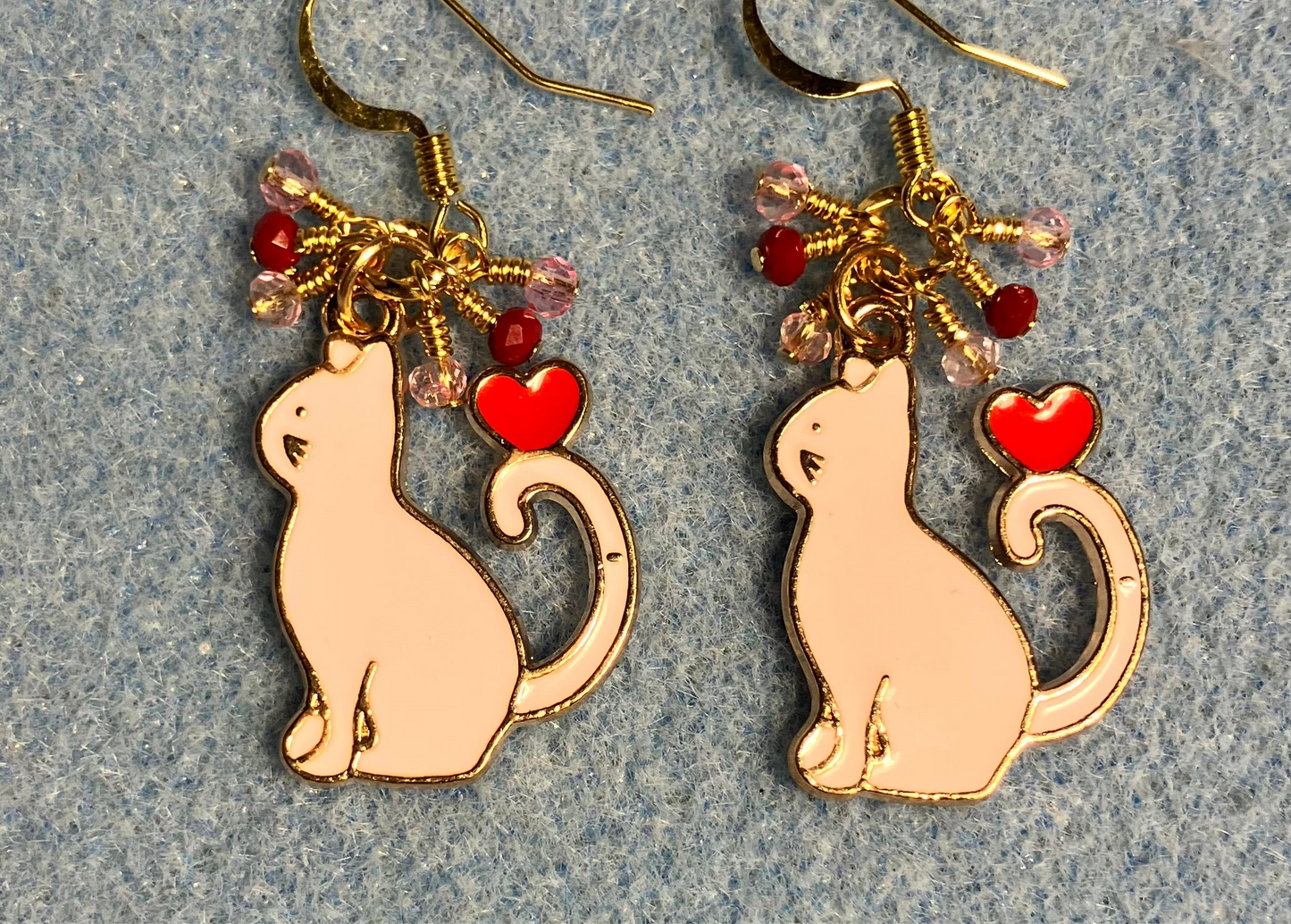 Pink and red enamel cat charm earrings adorned with tiny dangling pink and red Chinese crystal beads.