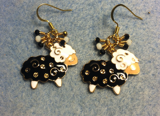 Black, gold, and white enamel sheep charm earrings adorned with tiny dangling black, gold and white Chinese crystal beads.