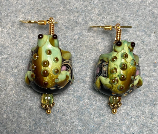 Large green and black lamp work frog bead earrings adorned with green Czech glass beads.