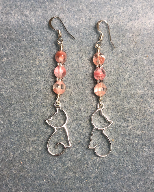 Silver silhouette cat charm earrings adorned with pink Czech glass beads.