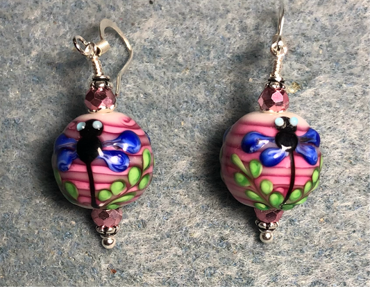 Pink, dark blue, and green lamp work dragonfly bead earrings adorned with hot pink Chinese crystal beads.