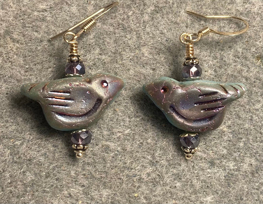 Metallic bluish purple Czech glass bird bead earrings adorned with violet Chinese crystal beads.