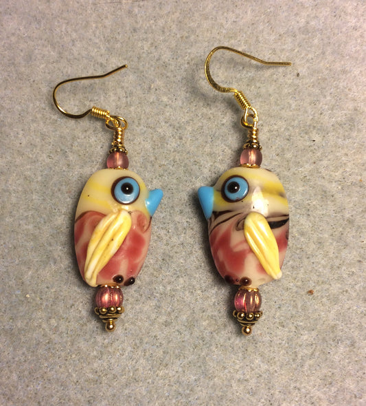 Pink, yellow, and blue lamp work bird bead earrings adorned with pink Czech glass beads.