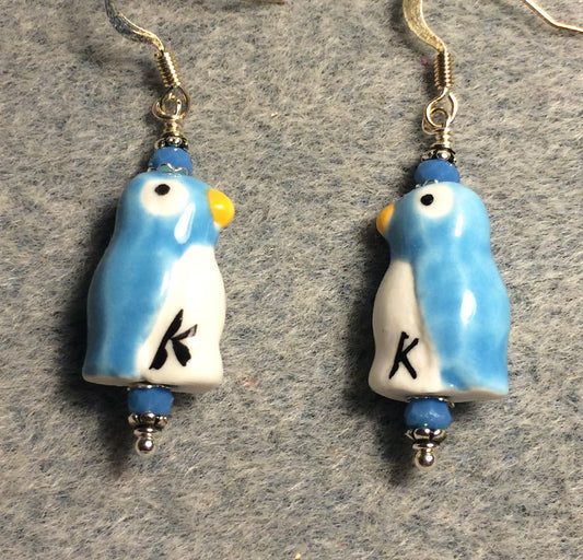 Light blue and white ceramic penguin bead earrings adorned with light blue Chinese crystal beads.