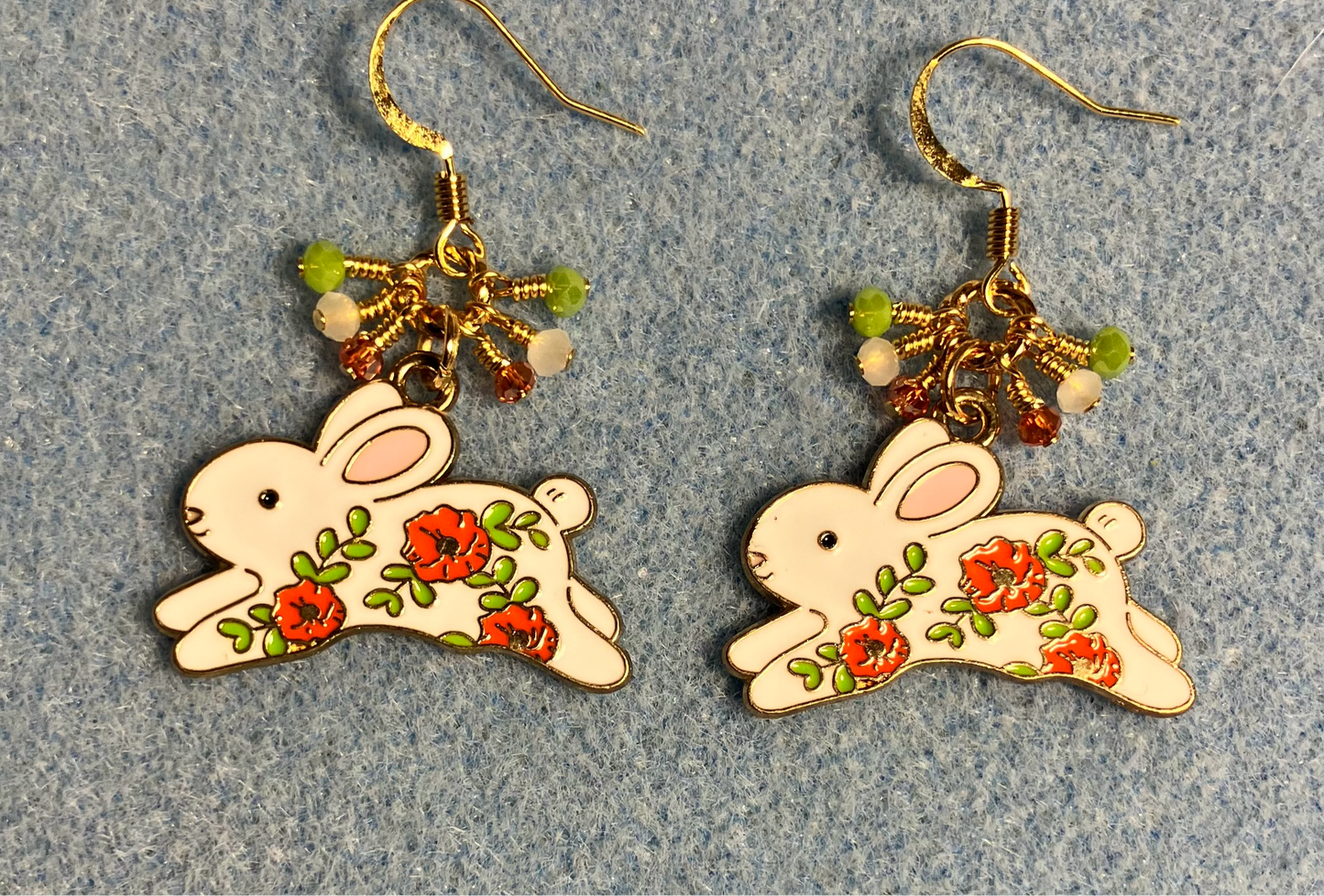 White, orange, and olive green enamel rabbit charm earrings adorned with white, orange, and olive green Chinese crystal beads.