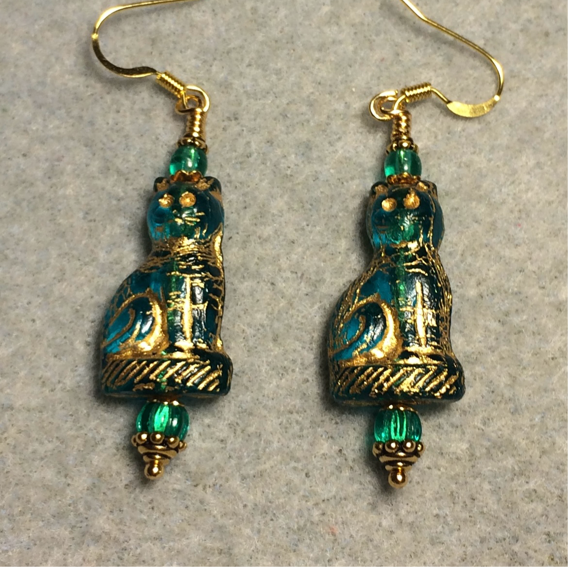 Translucent teal (with gold inlay) fancy Czech glass cat bead earrings adorned with teal Czech glass beads.