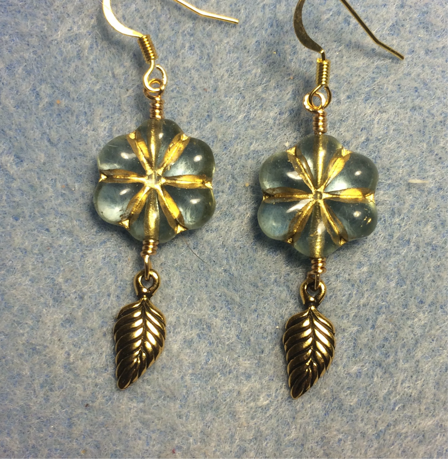 Clear (with gold inlay) Czech glass puffy flower bead earrings adorned with gold Tierracast leaf charms.