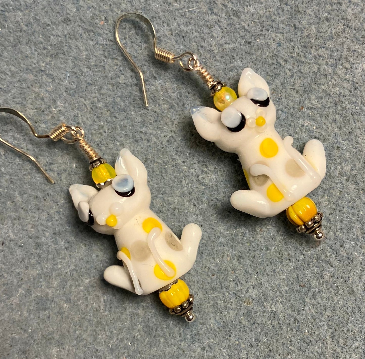 White and yellow lamp work cat bead earrings adorned with yellow Czech glass beads.