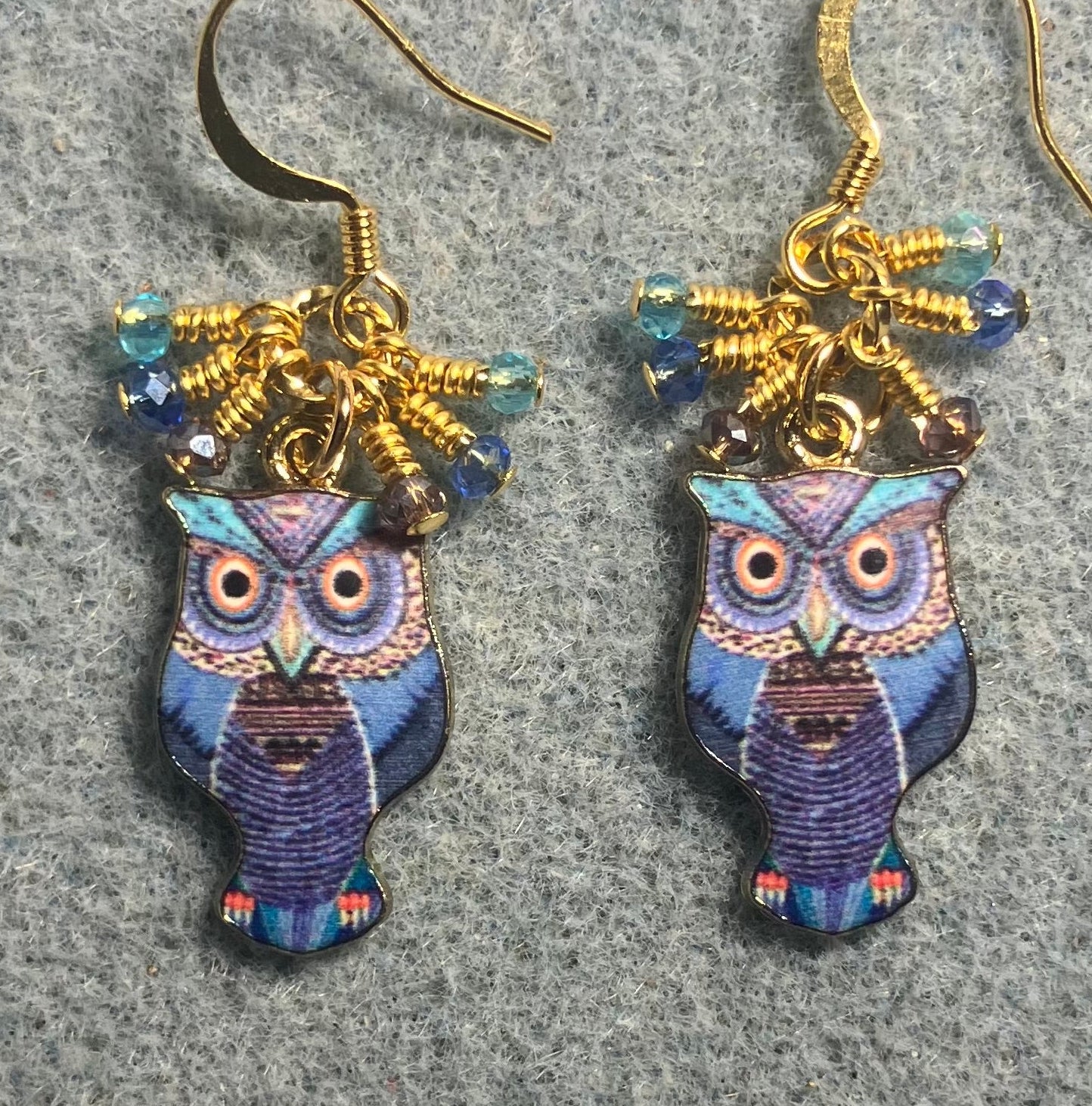 Dark blue, turquoise, and violet enamel owl charm earrings adorned with tiny dangling dark blue, turquoise, and violet Chinese crystal beads.